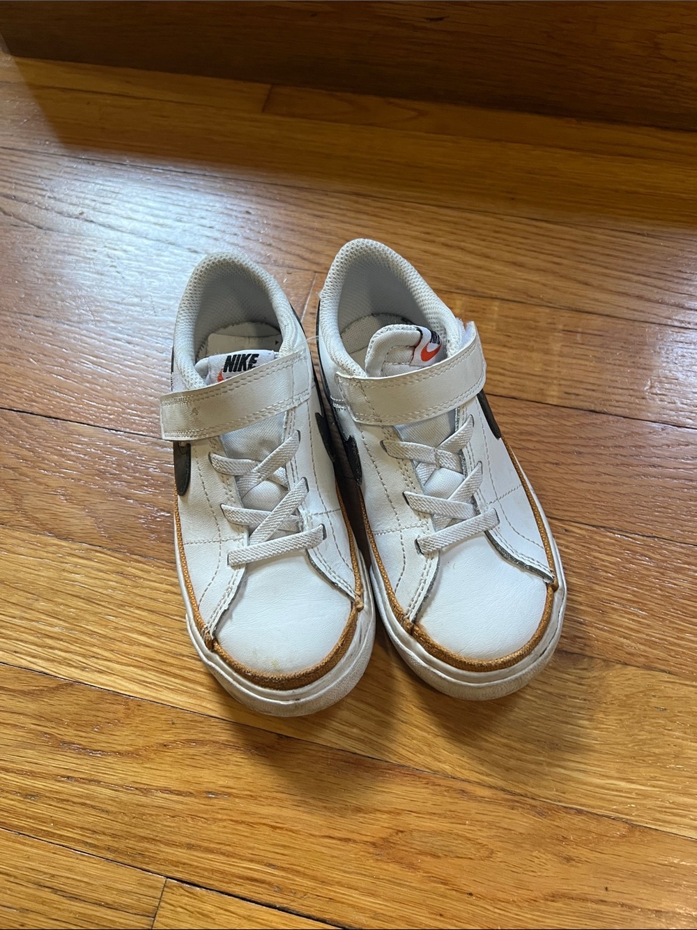 Nike Kids White Sneakers with Black Swoosh and Brown Trim